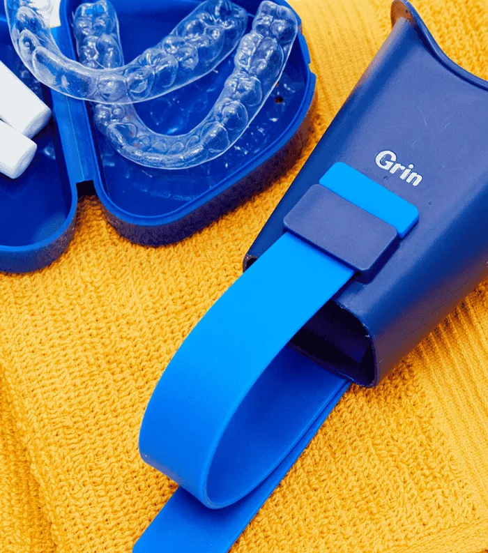A patient scanning their teeth with the Grin Scope attached to their phone